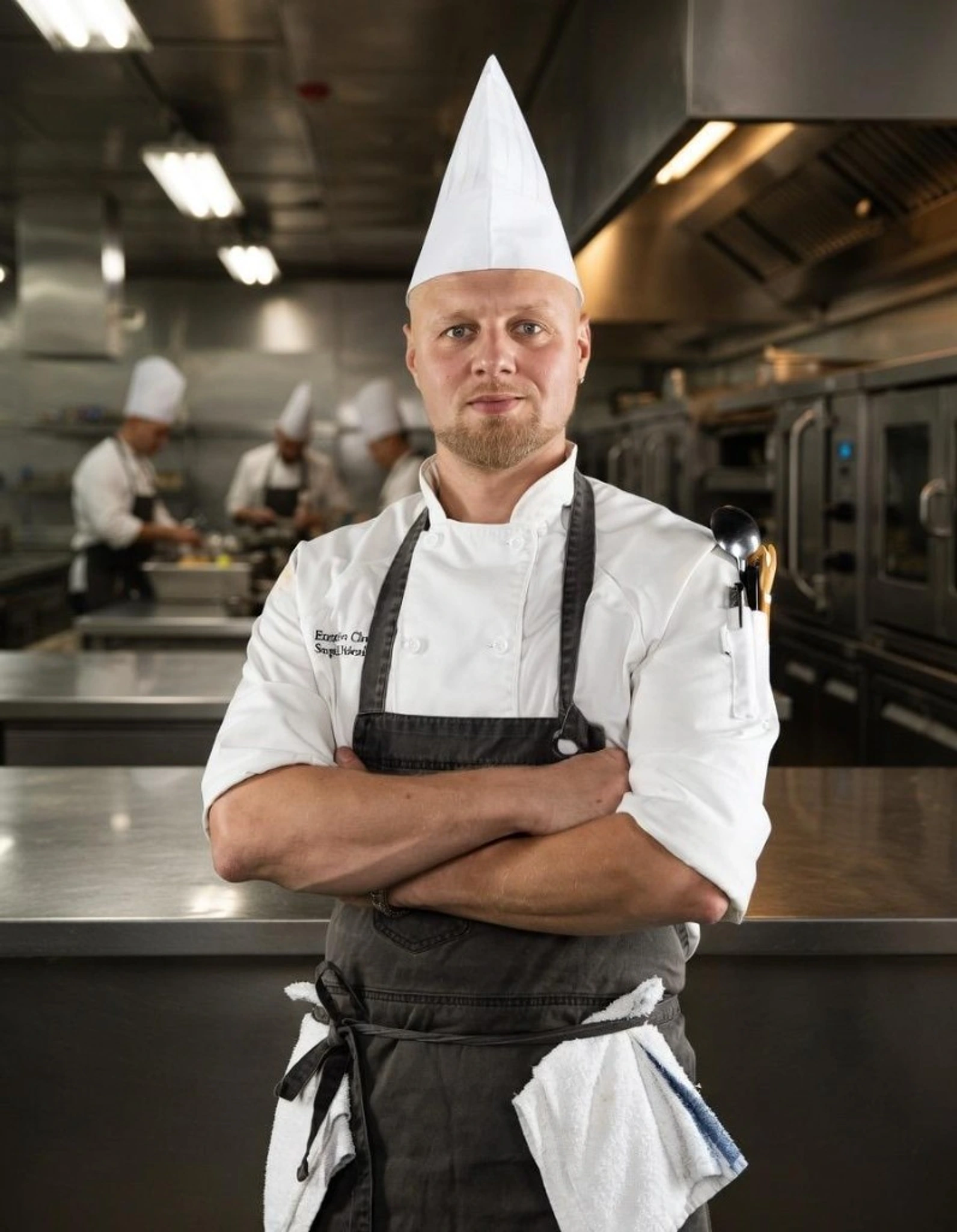 Chef Sergei Didenko in a professional kitchen, preparing a course